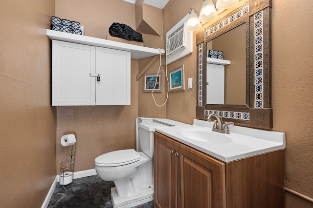 half bathroom with baseboards, vanity, and toilet