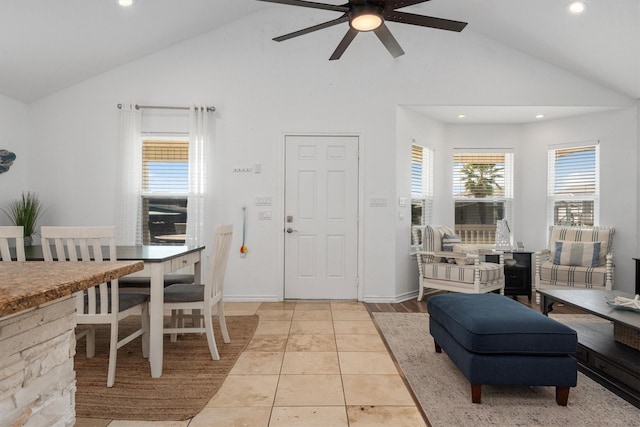 interior space with recessed lighting, a ceiling fan, light tile patterned flooring, high vaulted ceiling, and baseboards