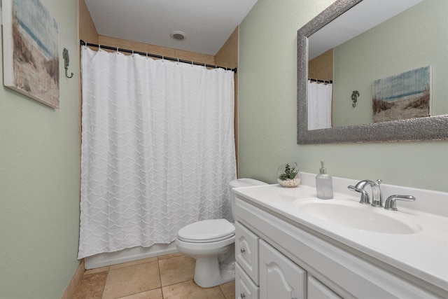 bathroom with toilet, tile patterned floors, and vanity