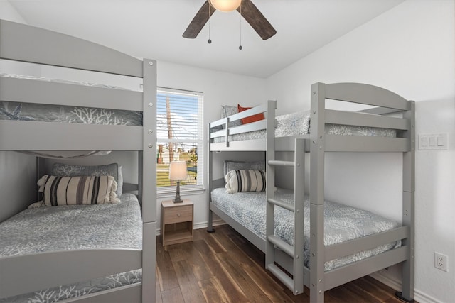 bedroom with lofted ceiling, dark wood-style floors, and a ceiling fan