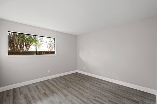 unfurnished room with hardwood / wood-style floors