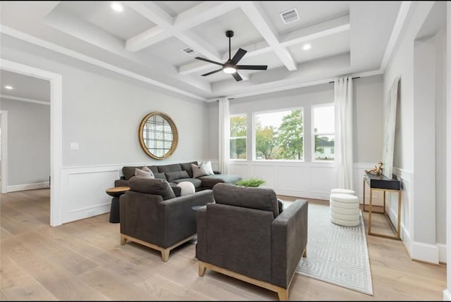 living room with coffered ceiling, crown molding, ceiling fan, beamed ceiling, and light hardwood / wood-style floors