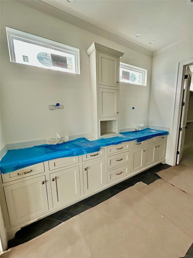 bathroom with tile patterned flooring and ornamental molding