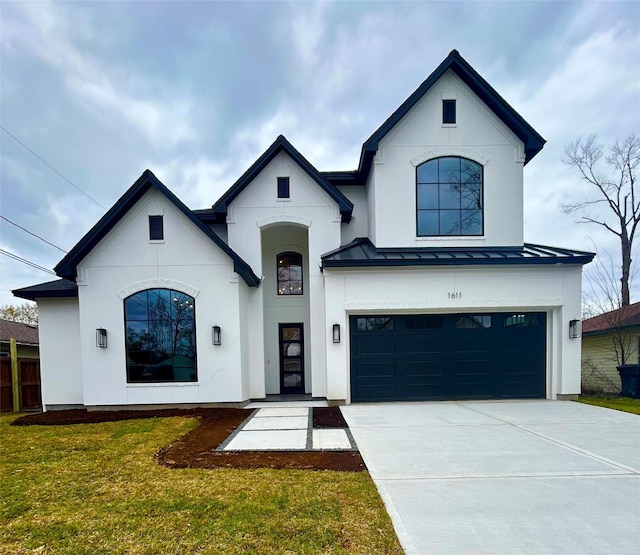 view of front of home with concrete driveway, a front yard, metal roof, a garage, and a standing seam roof