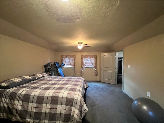 carpeted bedroom with ceiling fan and a textured ceiling