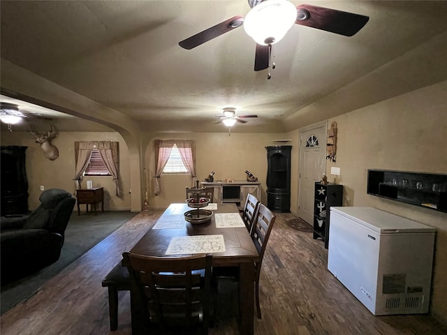 dining space with ceiling fan and carpet floors