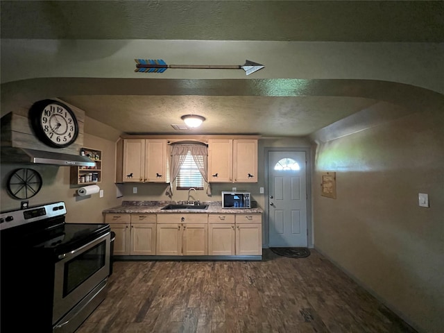 kitchen featuring dark hardwood / wood-style floors, light stone counters, stainless steel range with electric stovetop, a textured ceiling, and sink