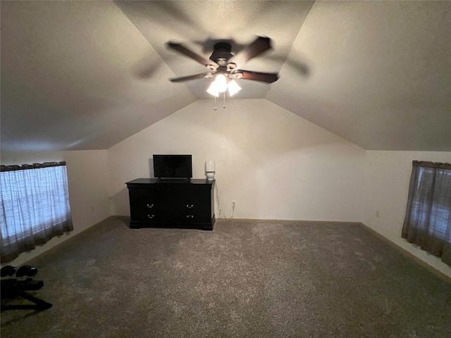 additional living space featuring ceiling fan, carpet, a textured ceiling, and vaulted ceiling