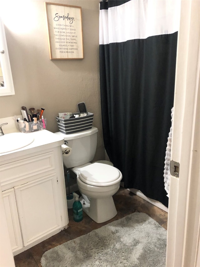 bathroom featuring toilet and vanity