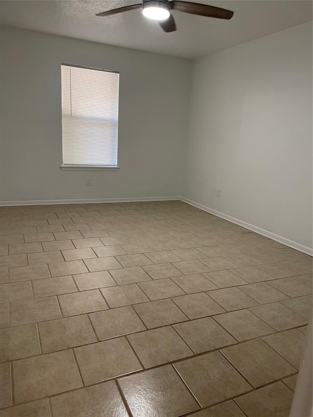 unfurnished room with ceiling fan, a textured ceiling, and light tile patterned floors