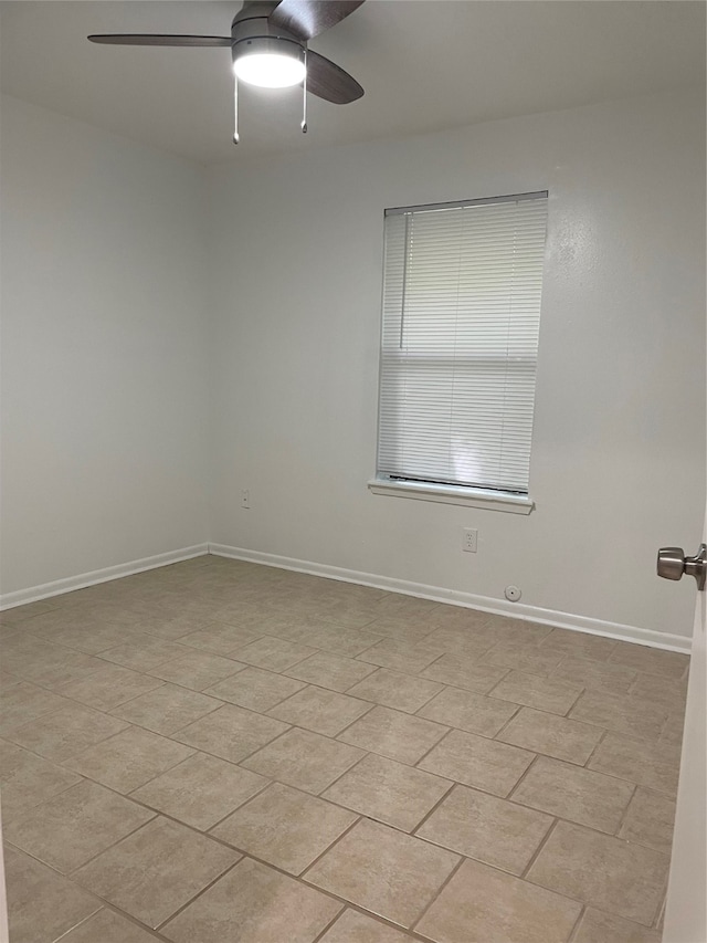 tiled empty room with ceiling fan