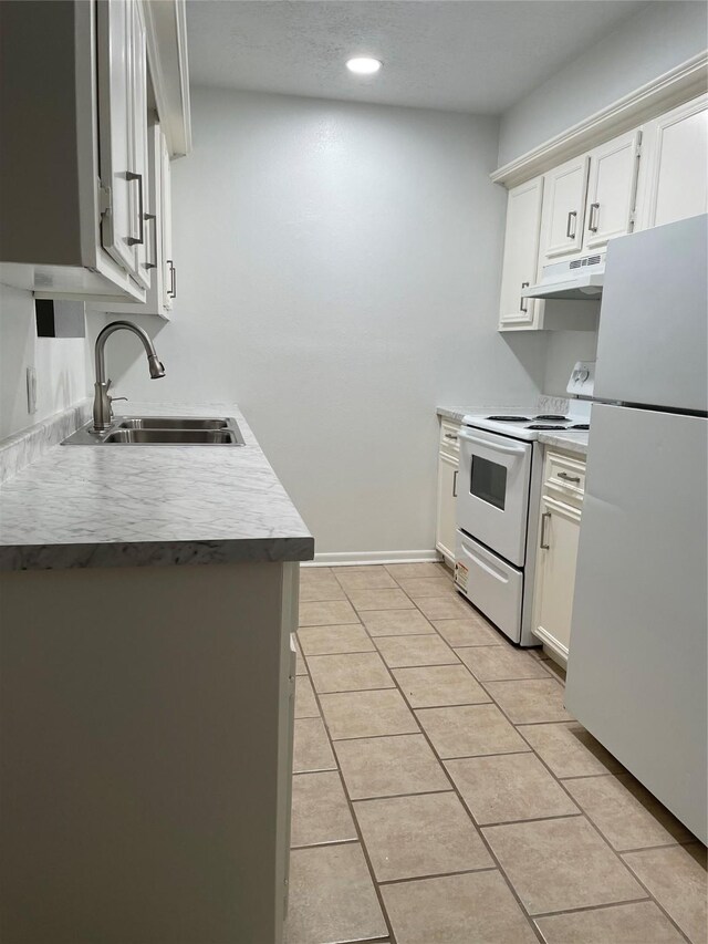 kitchen featuring white cabinets, sink, light tile patterned flooring, and white appliances