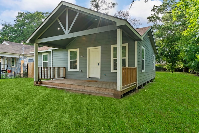 rear view of property featuring a lawn