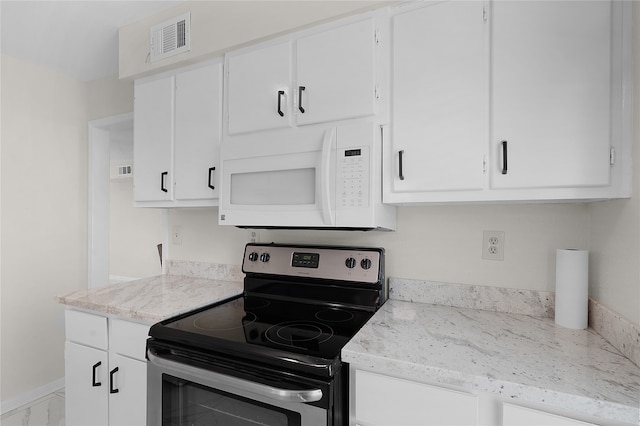 kitchen featuring light stone counters, white cabinetry, and stainless steel electric range