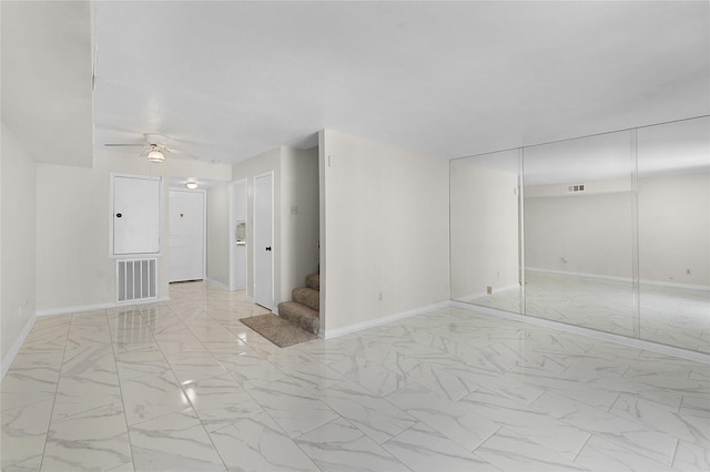 unfurnished room featuring stairs, marble finish floor, visible vents, and baseboards