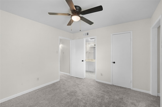 unfurnished bedroom with sink, carpet flooring, ceiling fan, and connected bathroom