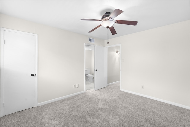 unfurnished bedroom featuring ceiling fan, connected bathroom, and light colored carpet