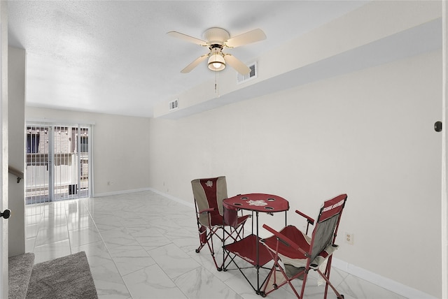 dining room with marble finish floor, baseboards, visible vents, and a ceiling fan