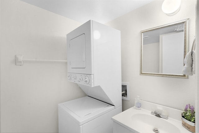 bathroom featuring stacked washer and clothes dryer and vanity