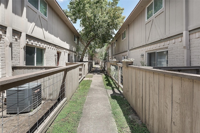 view of home's community featuring fence