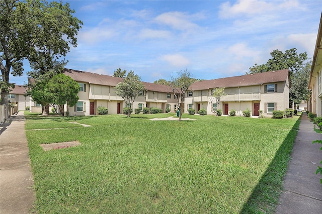 view of property's community featuring a residential view and a lawn