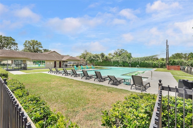 view of pool featuring a patio and a lawn