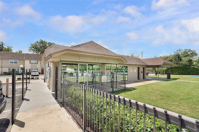 view of home's community with fence and a yard