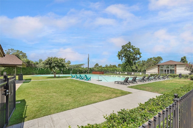 view of property's community featuring a lawn, a pool, and a patio area