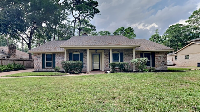 single story home featuring a front yard