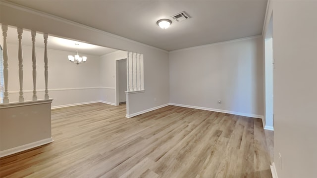 basement with light wood-type flooring, a notable chandelier, and crown molding