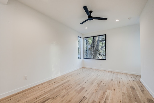 spare room featuring light wood-type flooring and ceiling fan