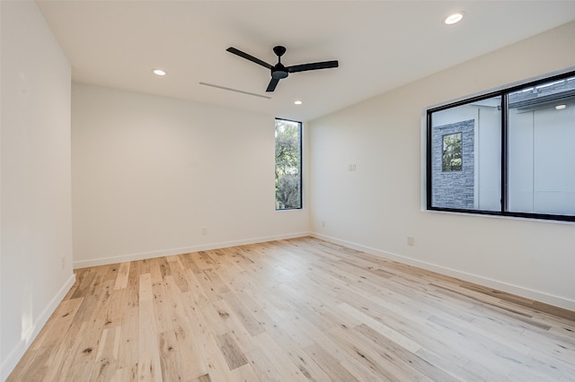 spare room with ceiling fan and light hardwood / wood-style flooring