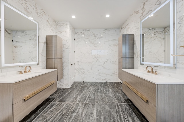 bathroom featuring vanity and tile walls