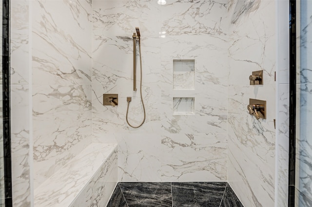 bathroom with a tile shower