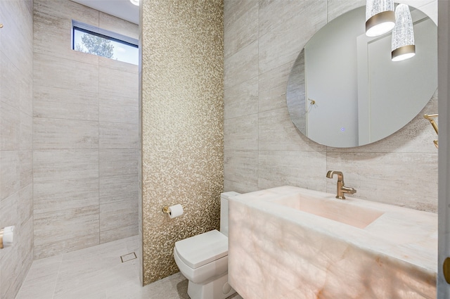 bathroom featuring vanity, toilet, and tile walls