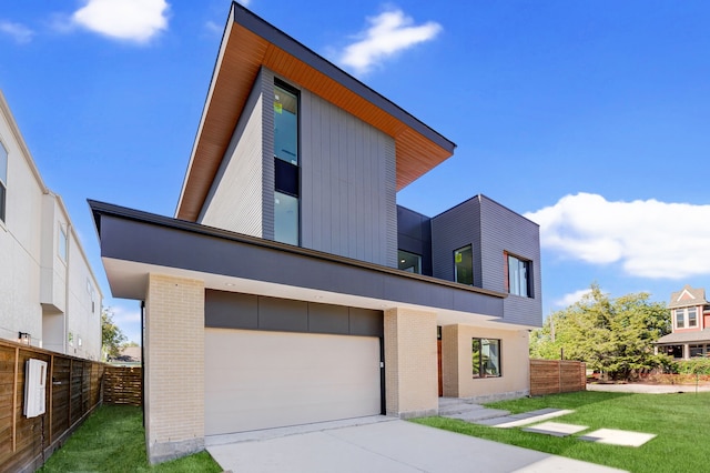 modern home with a garage and a front lawn