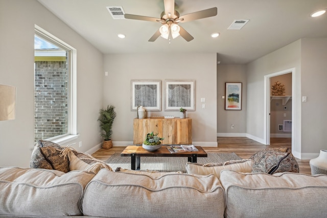 living room featuring ceiling fan and hardwood / wood-style floors