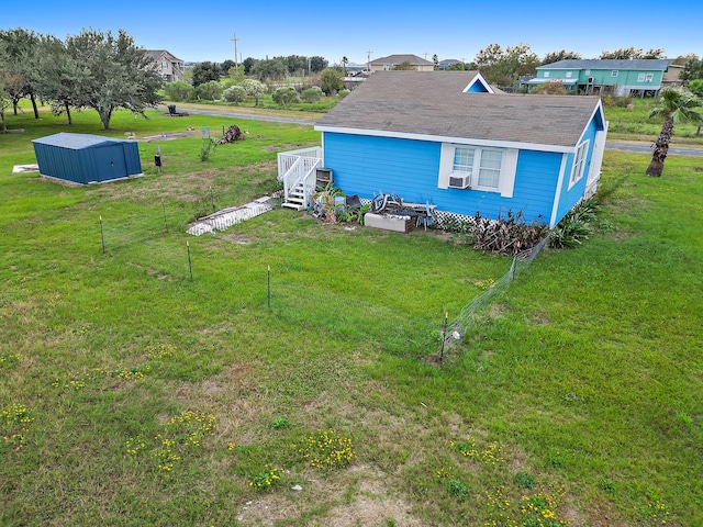 exterior space with cooling unit and a yard