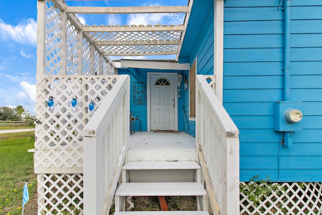 doorway to property featuring a pergola