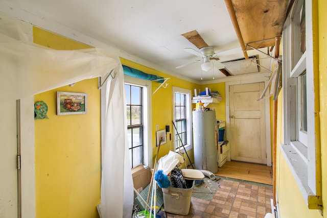 interior space featuring ceiling fan and gas water heater