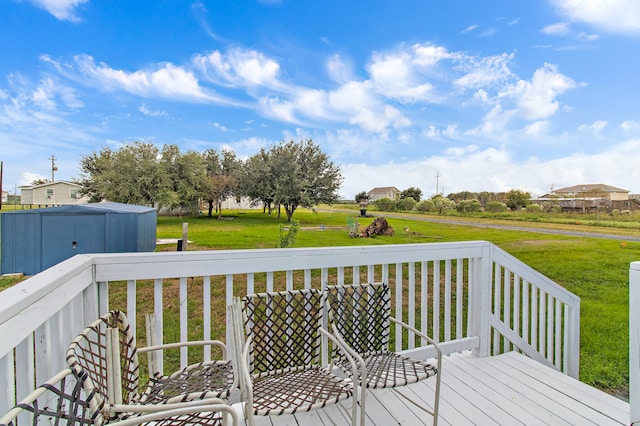 wooden terrace featuring a lawn