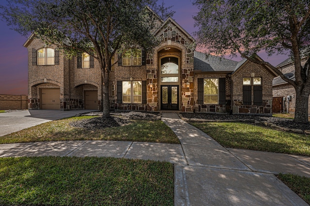 view of front of home featuring a lawn and french doors