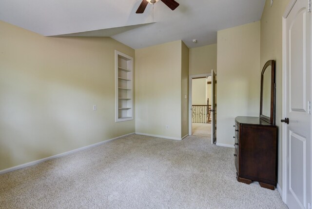 unfurnished bedroom featuring ceiling fan and light carpet