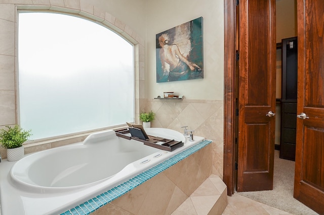 bathroom featuring tile walls and a bath