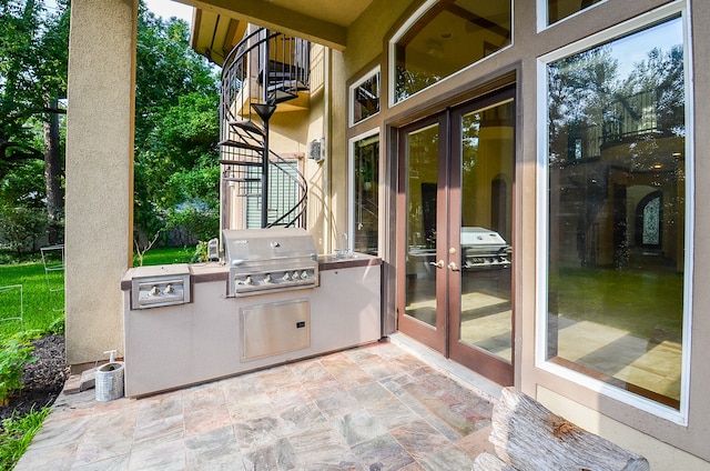 view of patio / terrace featuring french doors, area for grilling, an outdoor kitchen, and a balcony