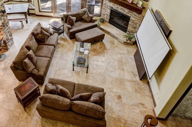 living area with a fireplace and baseboards