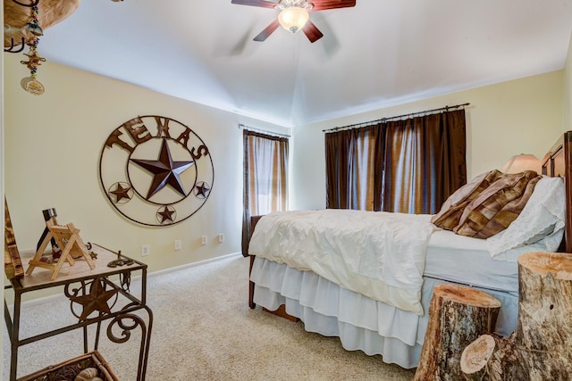 carpeted bedroom with a ceiling fan, lofted ceiling, and baseboards