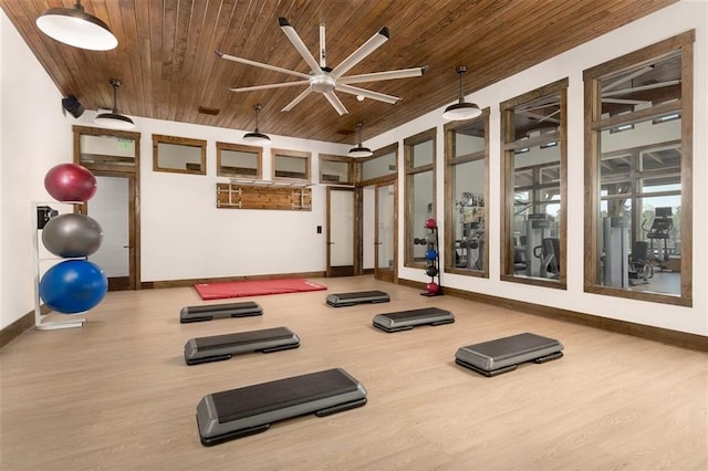 workout room with ceiling fan, wood ceiling, and hardwood / wood-style floors