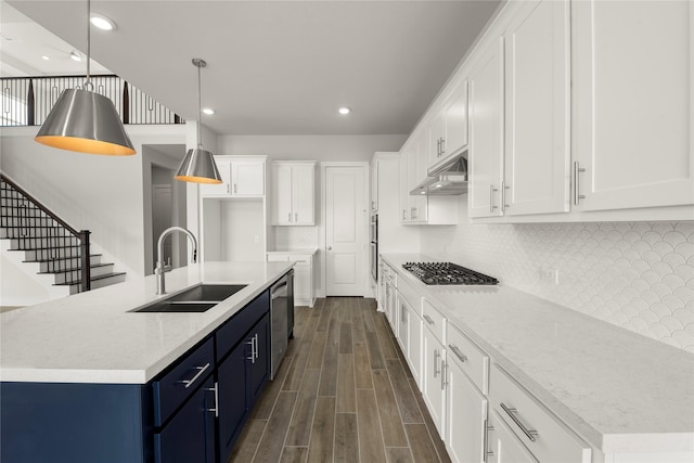 kitchen featuring a center island with sink, stainless steel appliances, white cabinetry, and sink