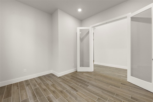 empty room featuring french doors and wood-type flooring